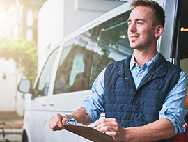 Delivery driver standing next to a cargo van